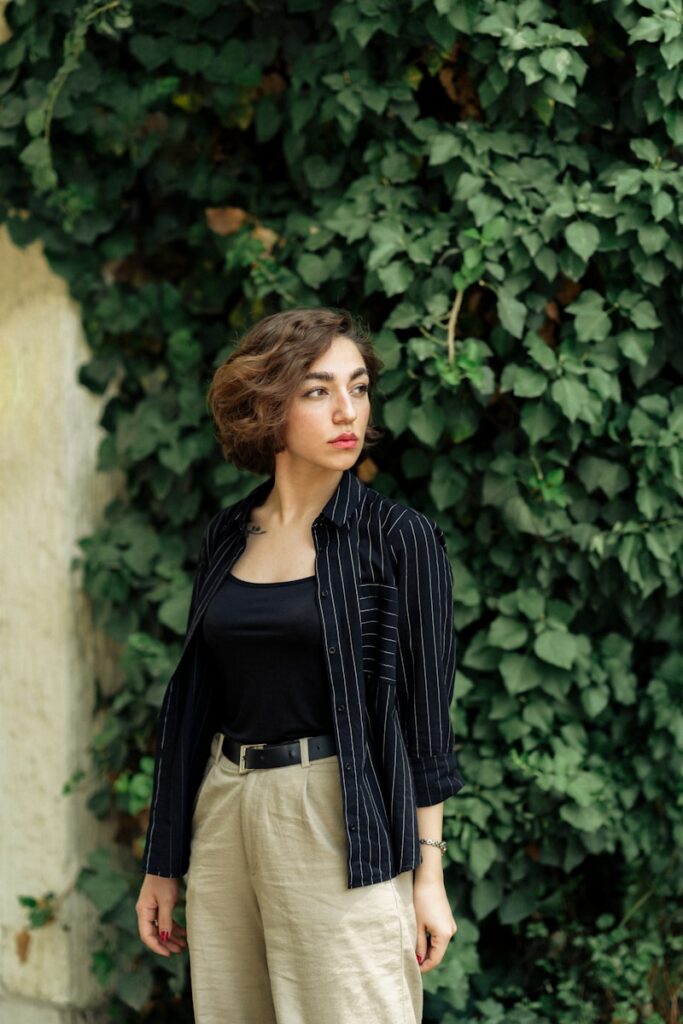 A woman standing in front of a green wall